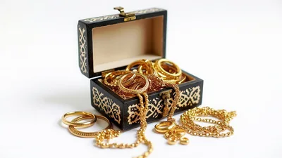 Open Wooden Jewelry Box Filled With Gold Accessories