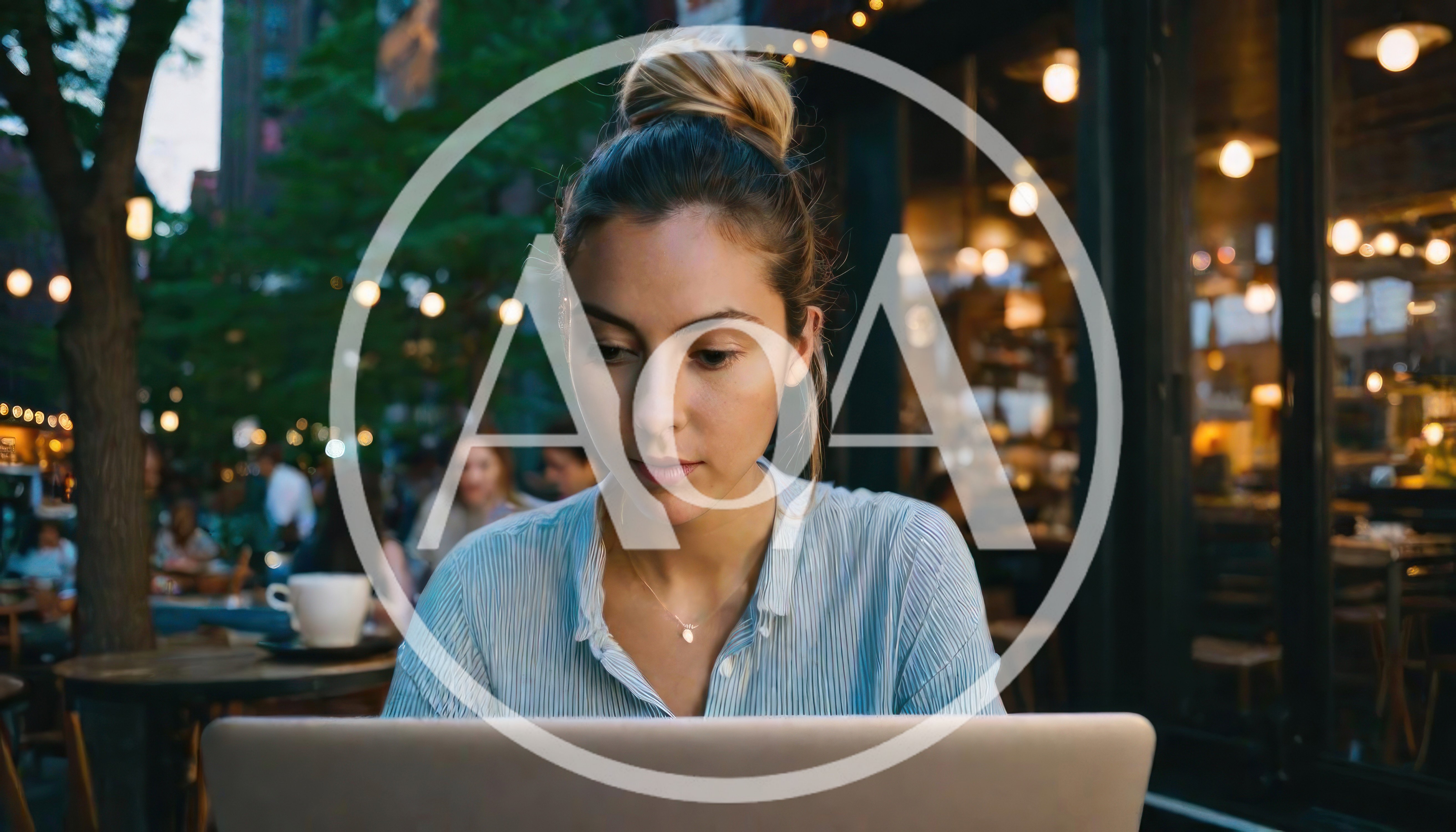 Young Woman Working On Laptop At Outdoor Cafe