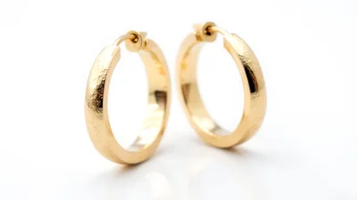 Pair Of Gold Hoop Earrings On White Background