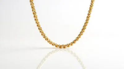 Gold Rope Chain Necklace On White Background
