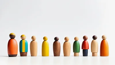 Row Of Colorful Wooden Peg Dolls On White Background