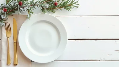 Christmas Table Setting With Gold Cutlery And Pine Branch