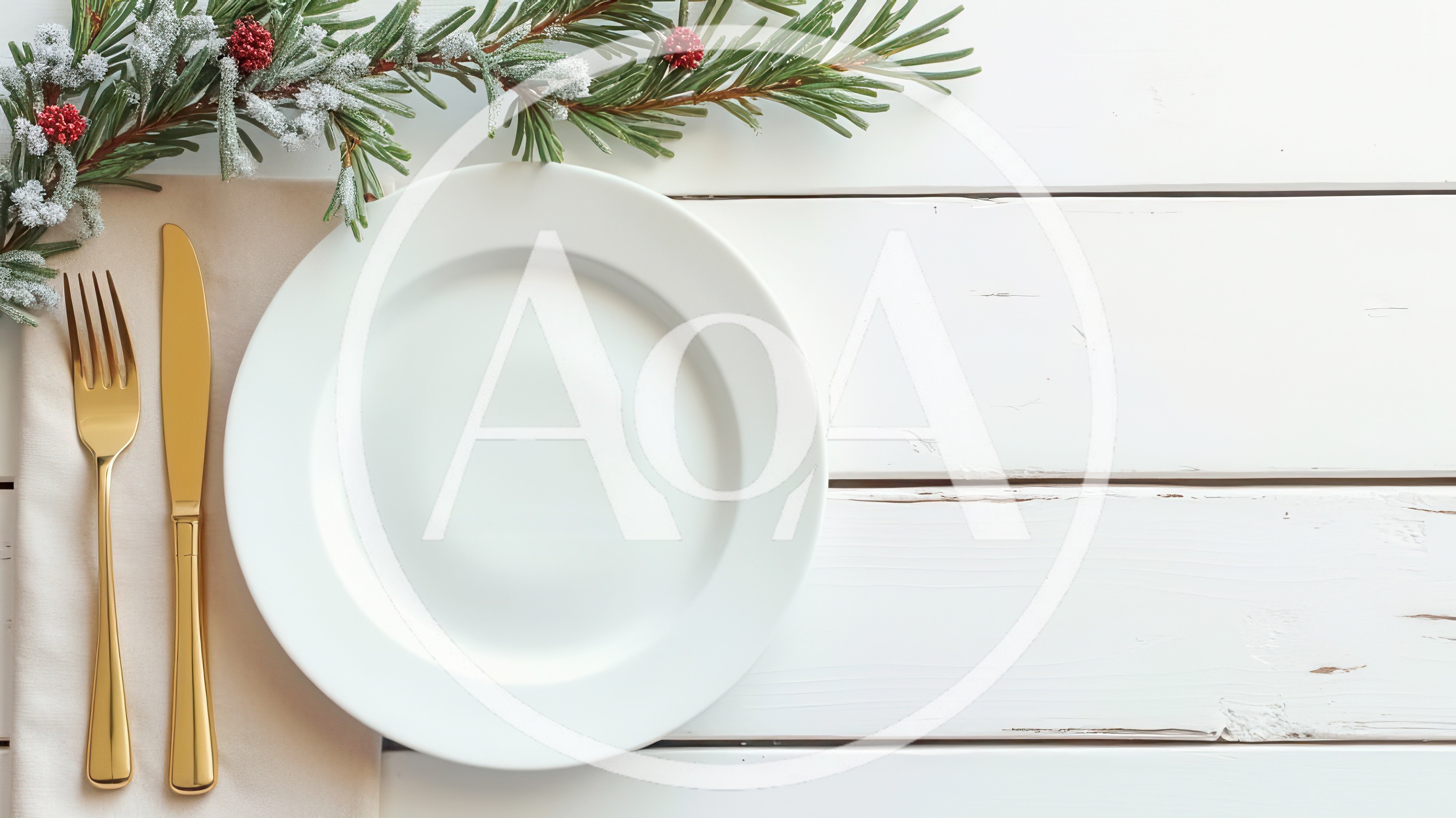 Christmas Table Setting With Gold Cutlery And Pine Branch