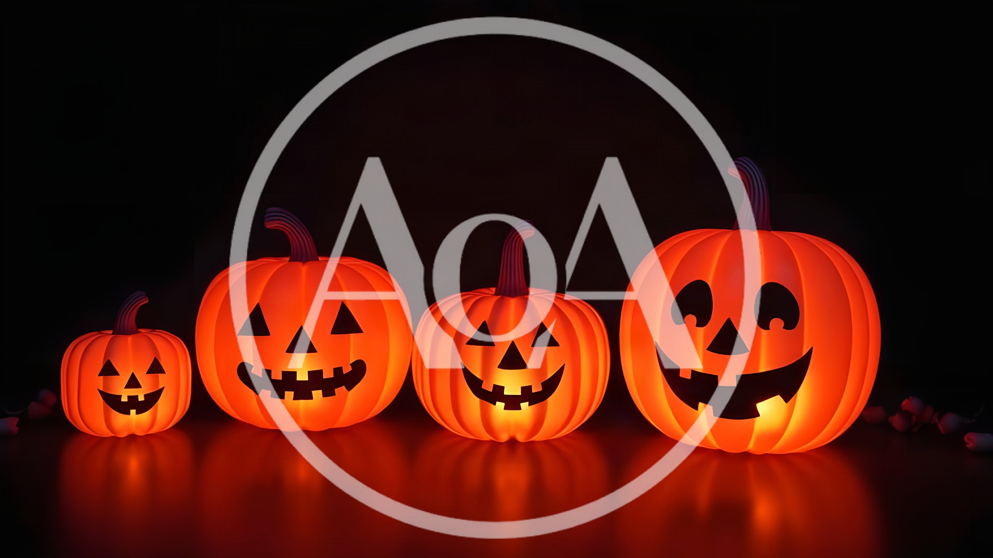 Four Glowing Jack O Lanterns In A Row