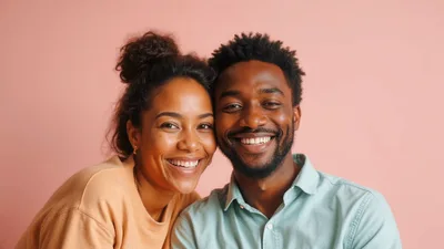 Happy Young Couple Smiling Together Against Pink Background