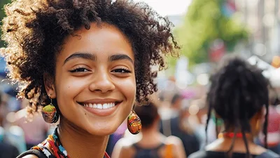 Smiling Young Woman With Curly Hair At Outdoor Festival