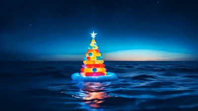 Glowing Inflatable Christmas Tree Floating On Dark Ocean