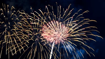 Bright Golden And Red Fireworks Exploding In Night Sky