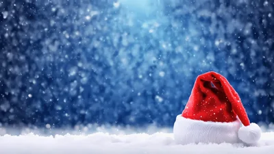 Santa Claus Hat Resting On Snowy Ground During Snowfall