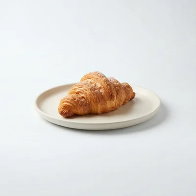 Fresh Golden Croissant On A Minimalist Plate
