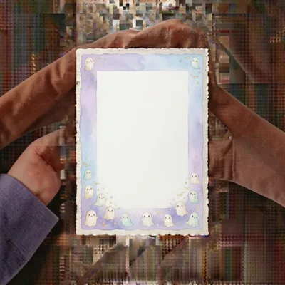 Hands Holding A Cute Ghost Themed Stationery Paper