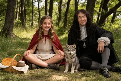 Little Red Riding Hood with Charles Perrault and cute wolf cub, in the forest, medieval France