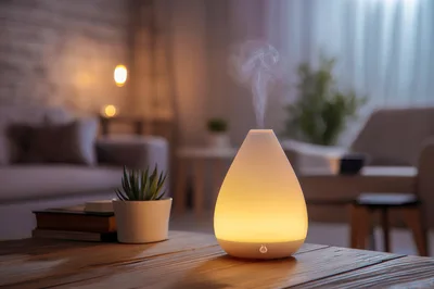 Essential Oil Diffuser Emitting Mist On Wooden Table