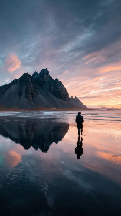 Lone Hiker Walking Along Vestrahorn Mountain Beach