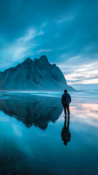 Man Standing On Vestrahorn Beach At Sunset