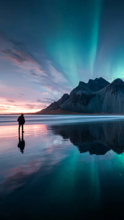 Person Standing On Beach Under Aurora Borealis