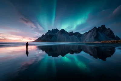 Person Standing On Beach Under Aurora Borealis