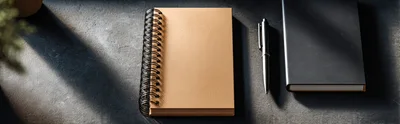 Top View Of Notebooks And Pen On Dark Desk