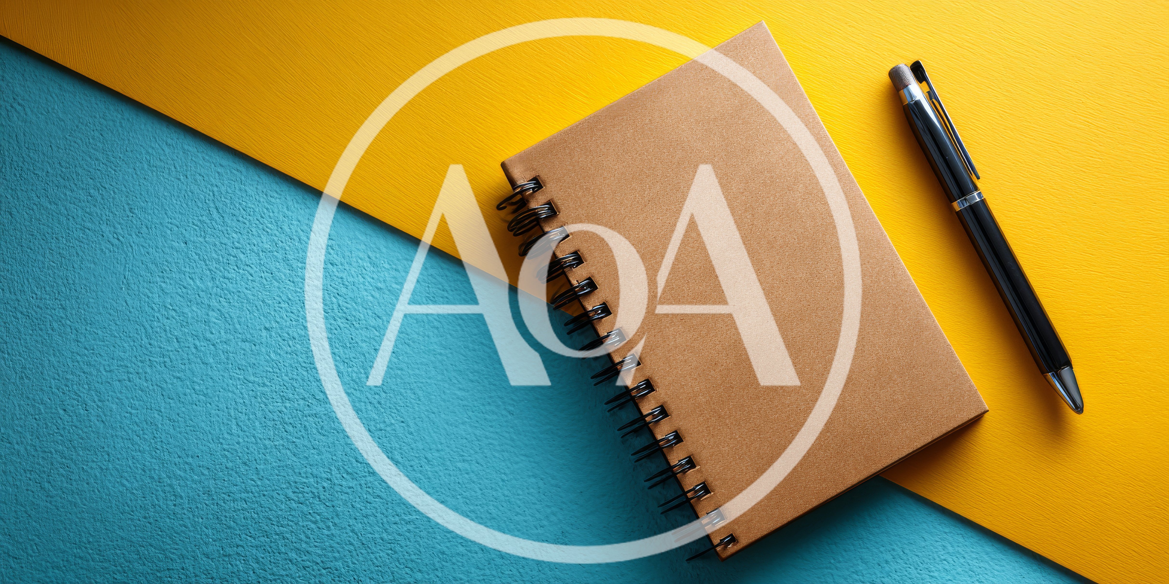 Spiral Notebook and Pen on Two Tone Background