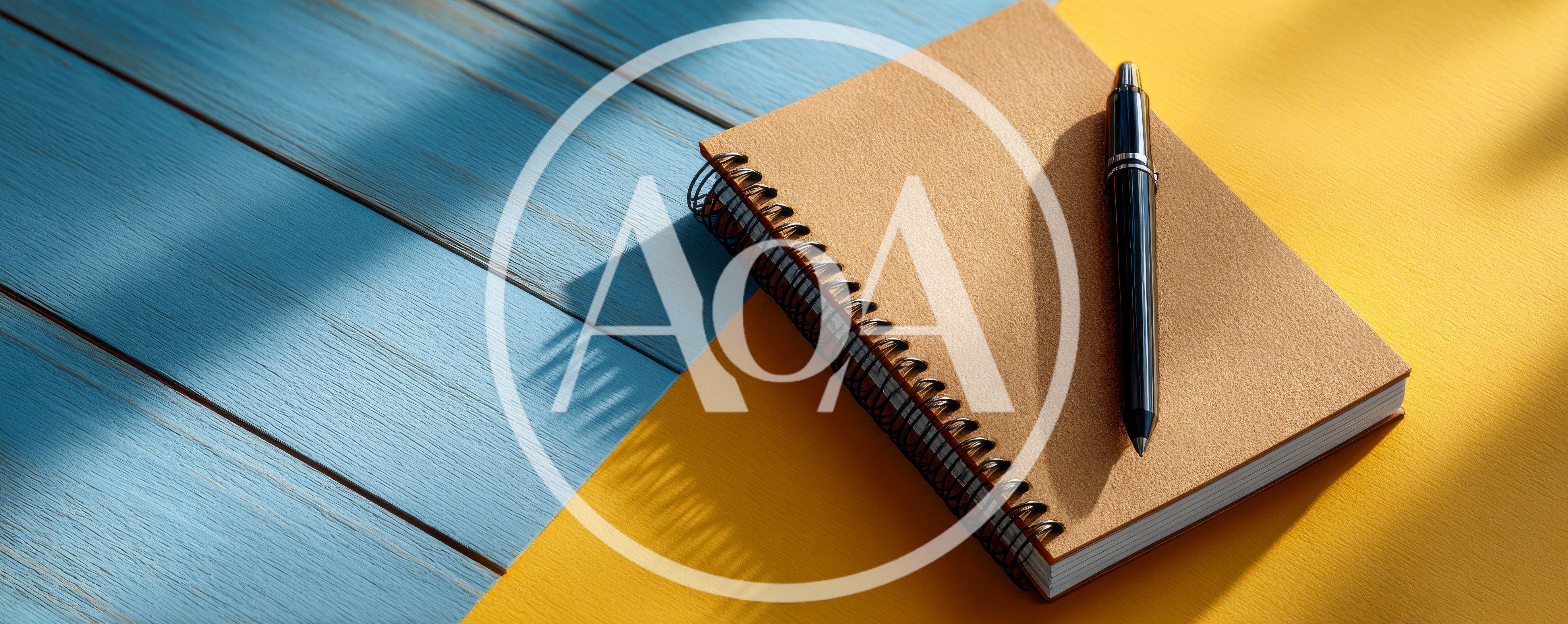 Spiral Notebook With Black Pen On Two Tone Background
