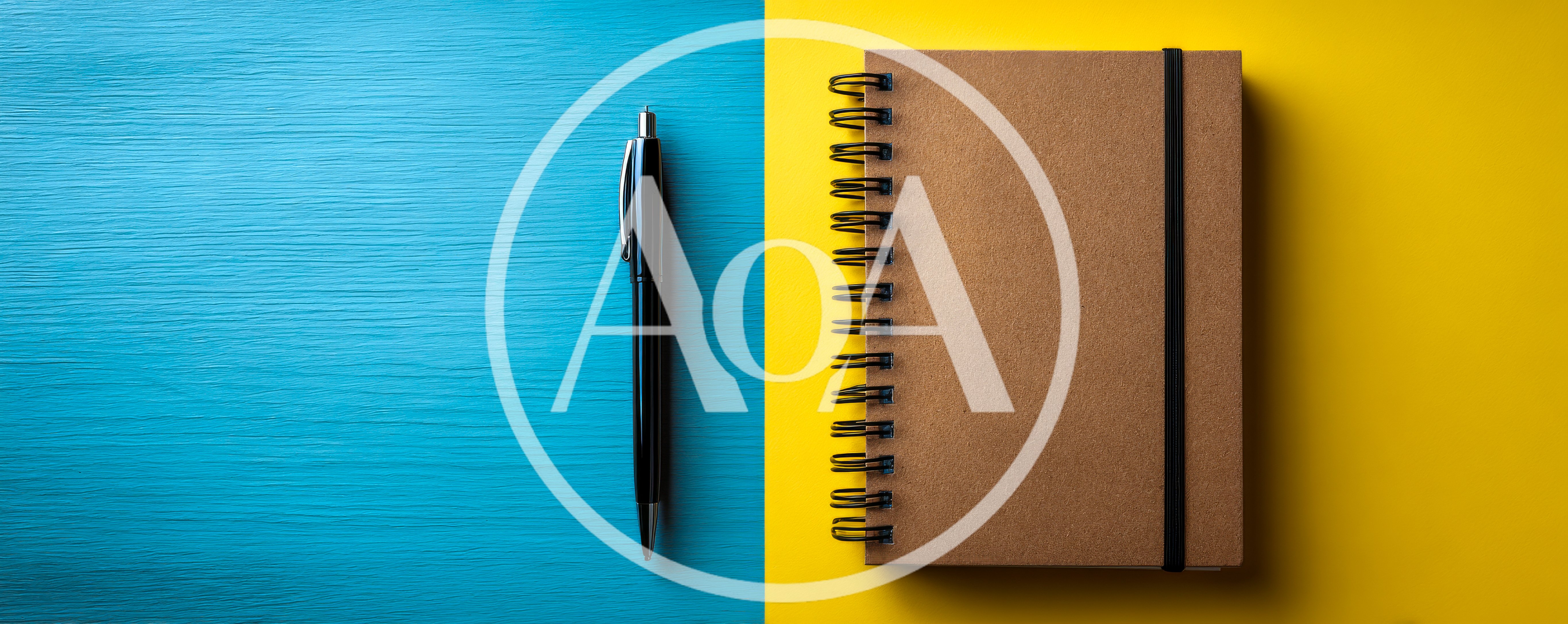 Black Pen And Spiral Notebook On Split Background