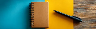 Spiral Notebook and Black Pen on Colorful Background