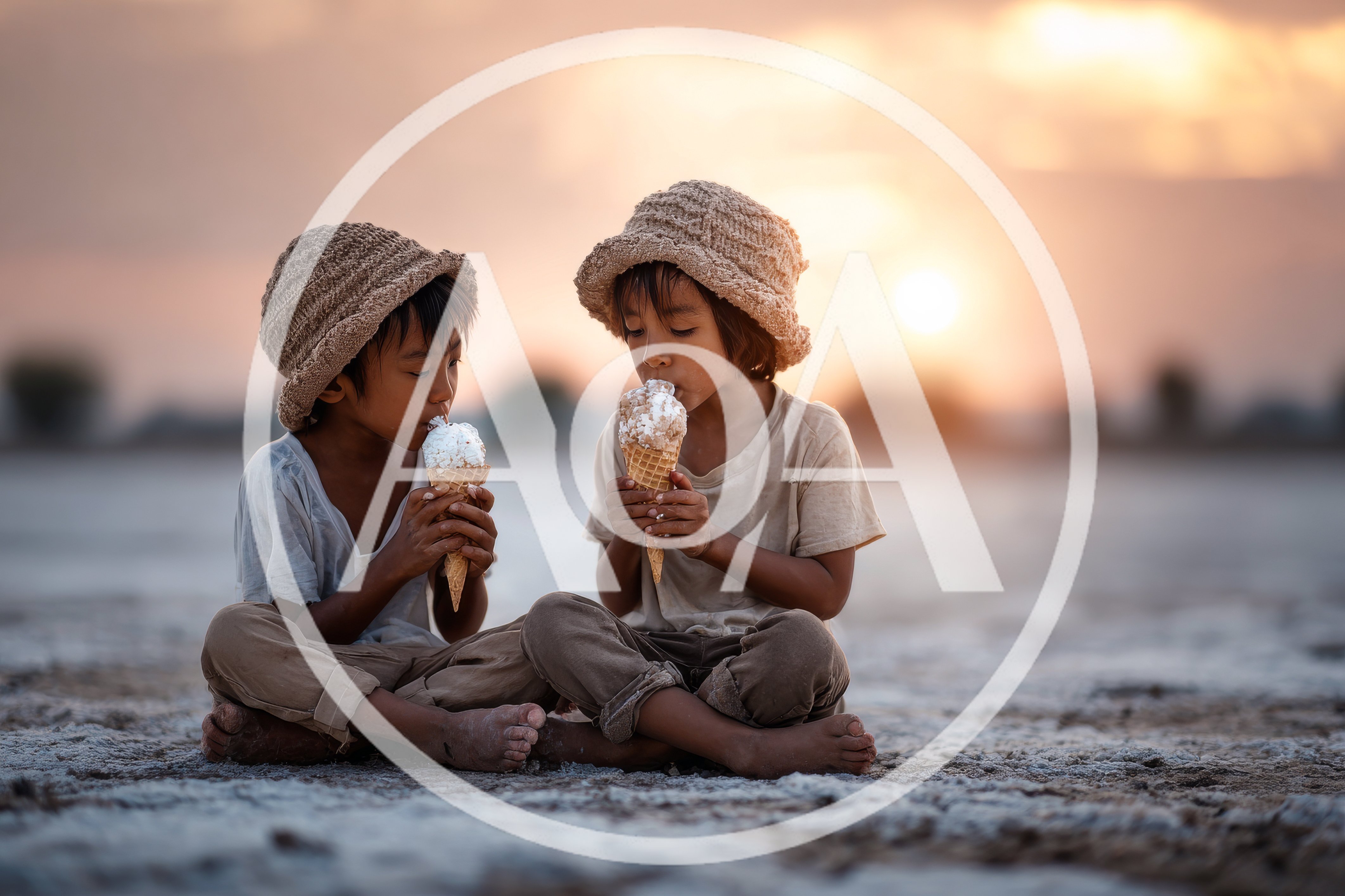 Two Young Children Eating Ice Cream Cones at Sunset
