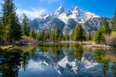 Grand Teton Mountains Reflected In Calm Pond