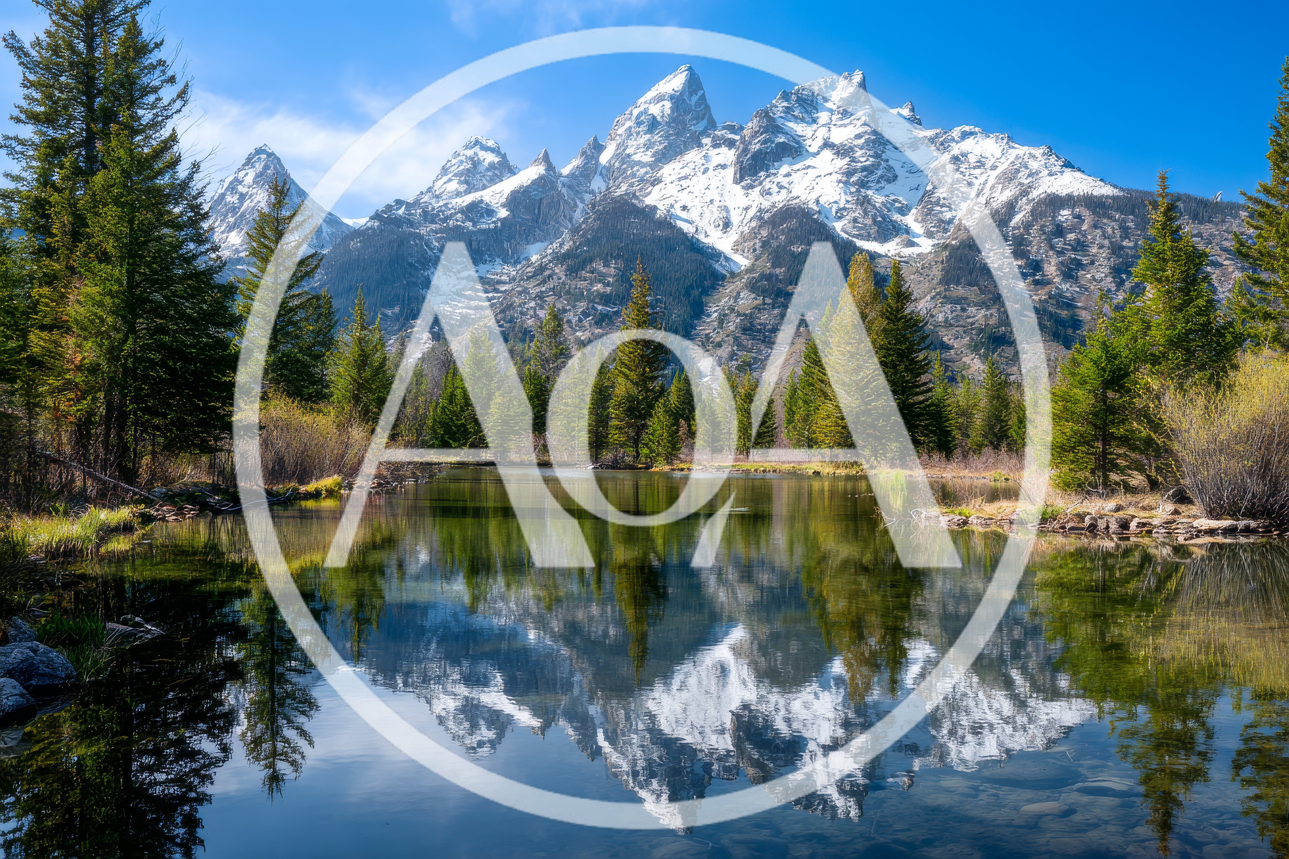 Grand Teton Mountains Reflected In Calm Pond