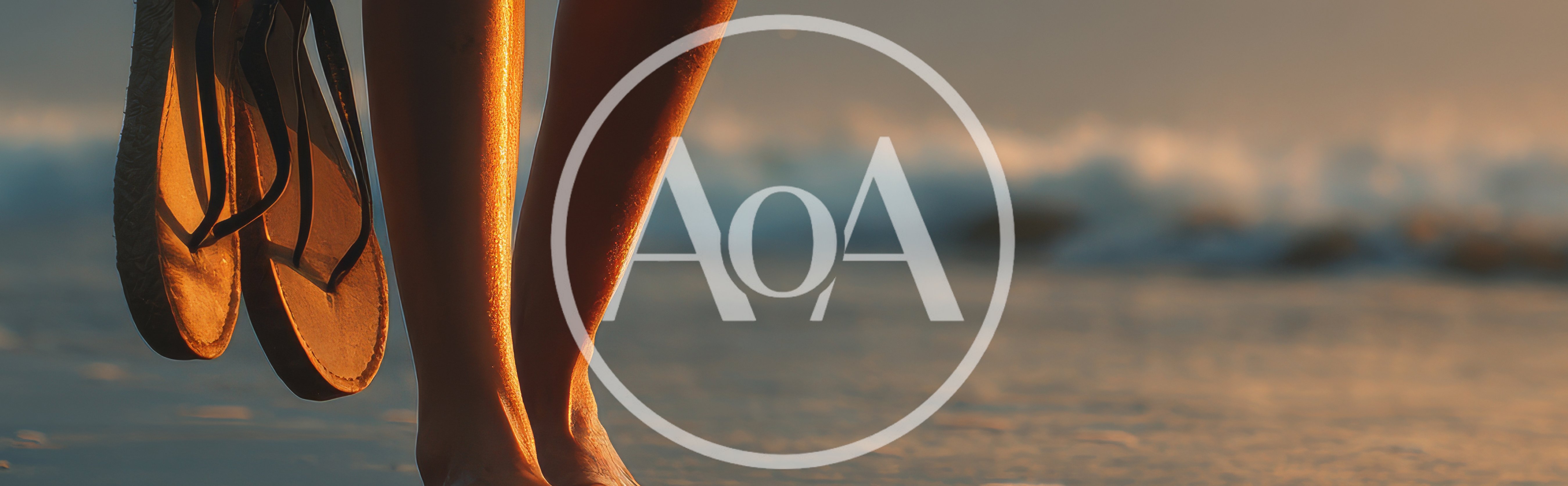 Woman Holding Flip Flops Walking Along The Beach