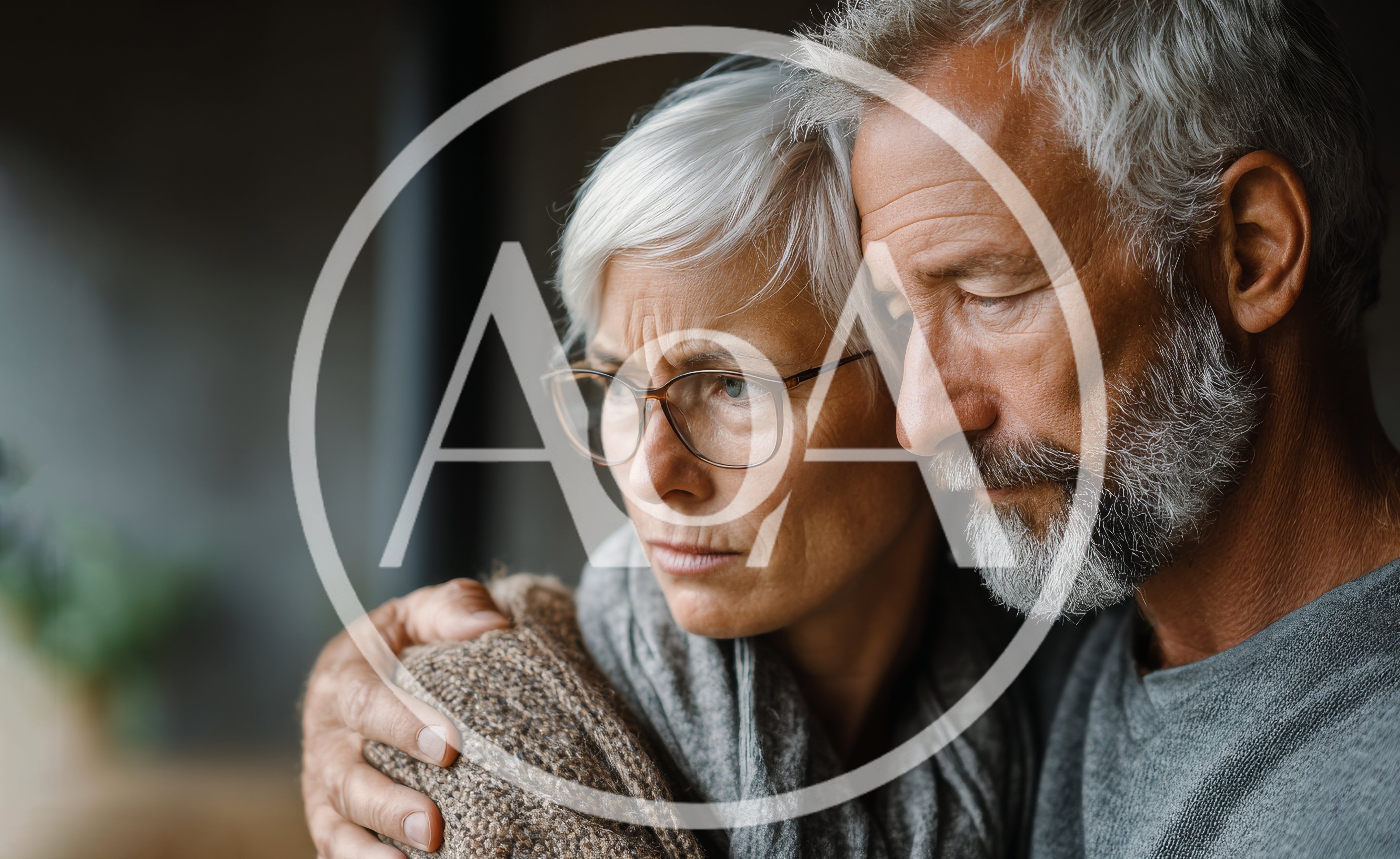 Senior Couple Embracing In A Moment Of Shared Grief