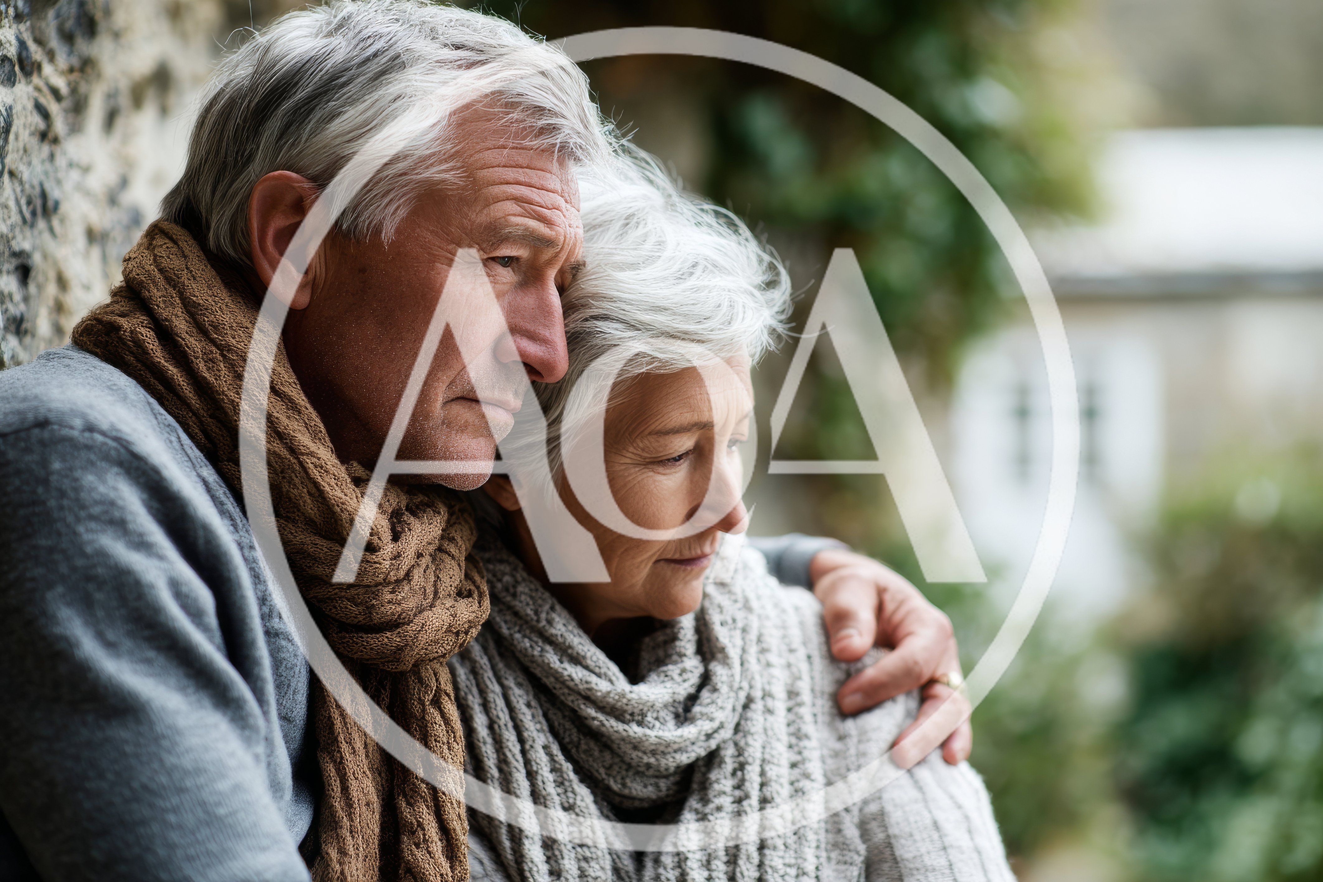 Senior Couple Embracing Outdoors in Thoughtful Reflection