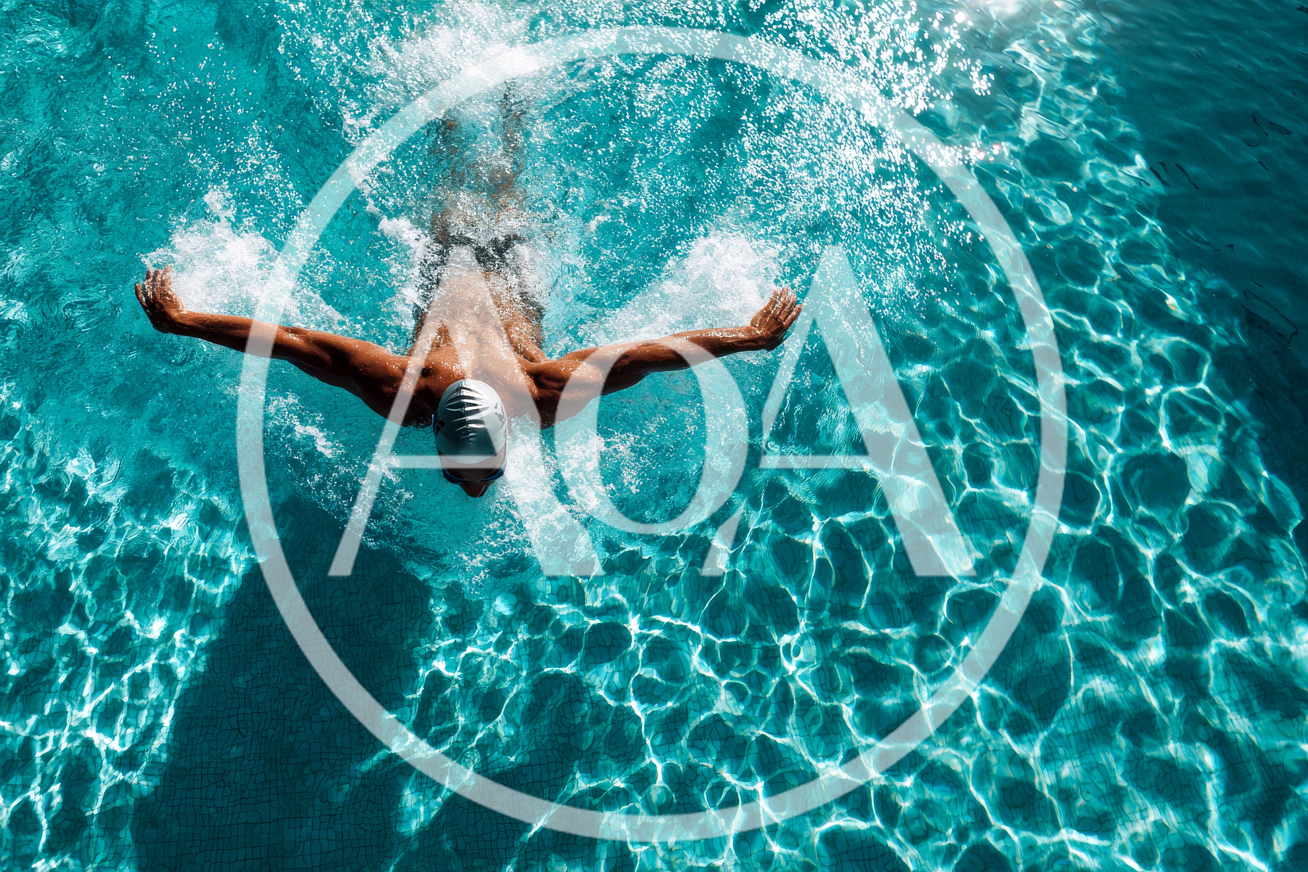Professional Swimmer Performing Butterfly Stroke In Pool
