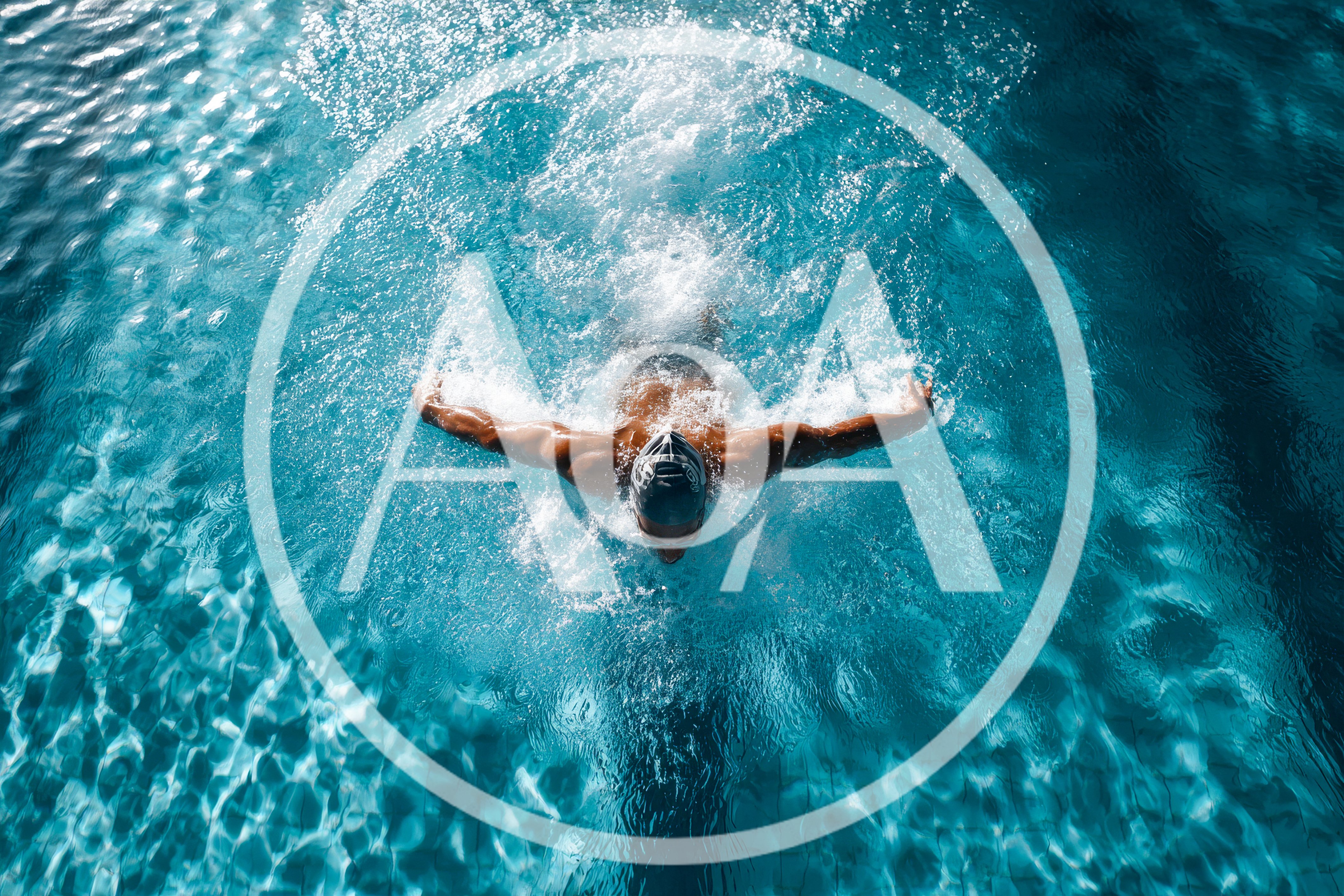 Professional Swimmer Performing Butterfly Stroke In Pool