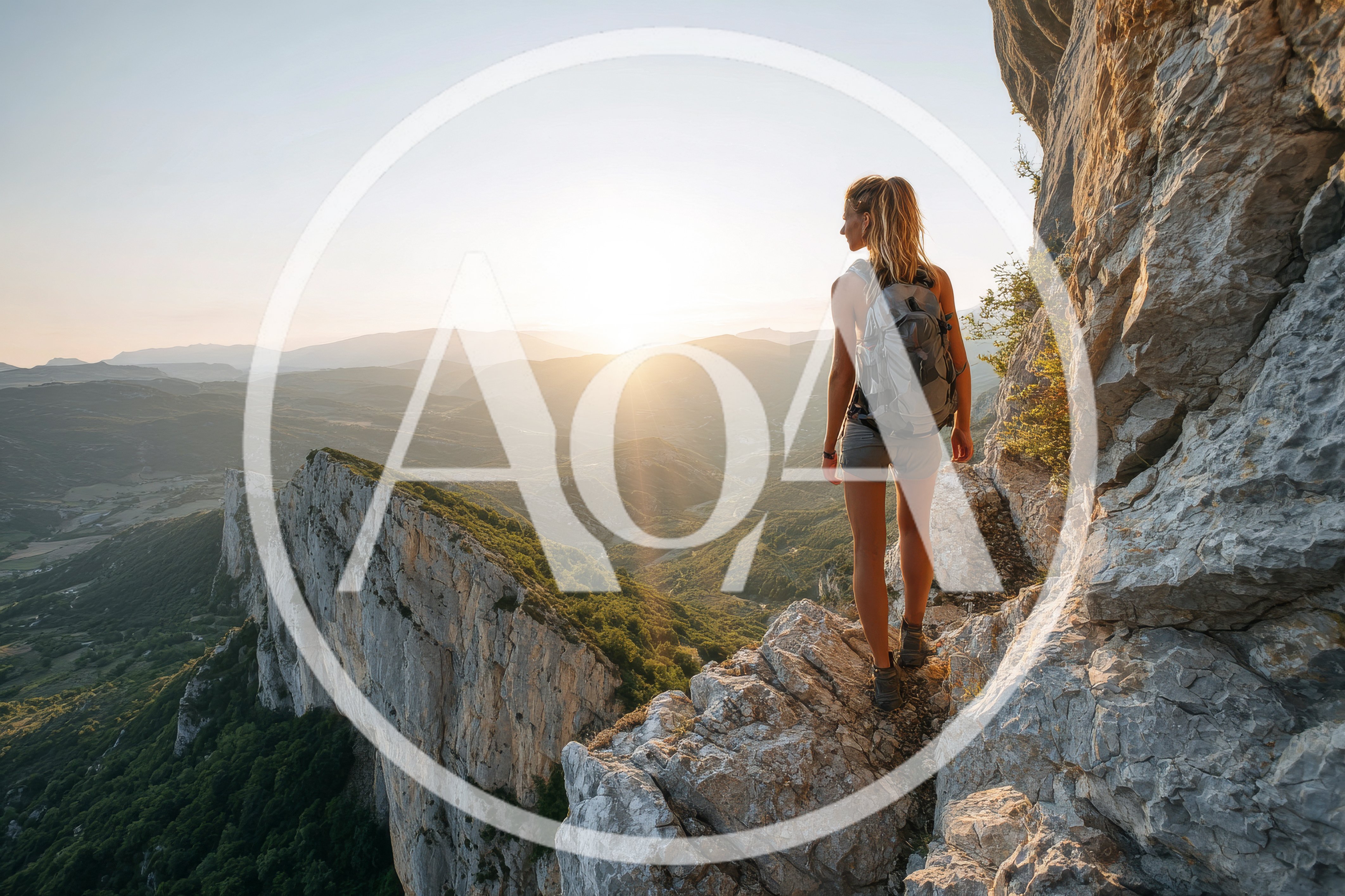 Woman Hiking On A Mountain Ridge At Sunset