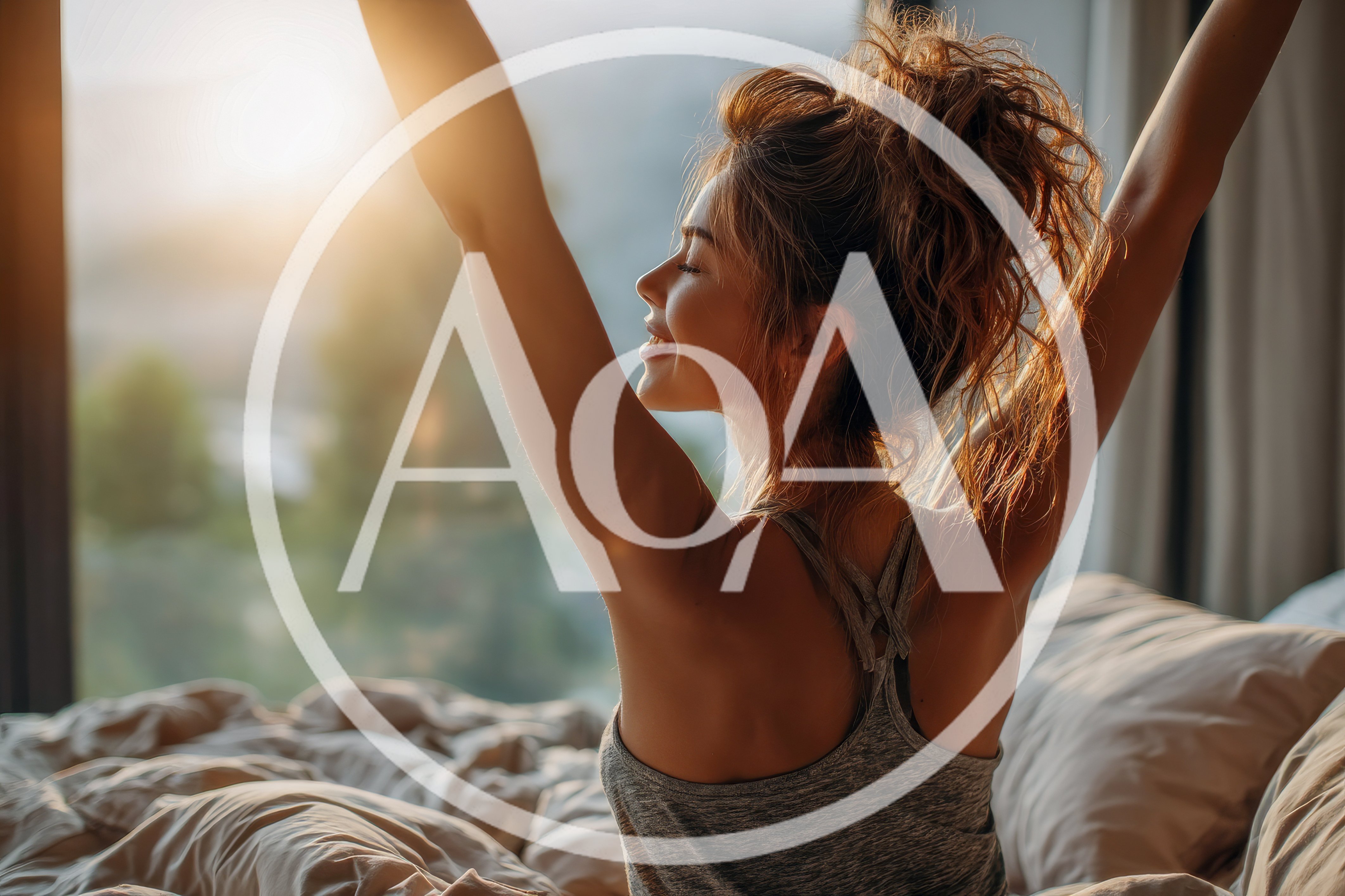Young Woman Stretching In Bed At Sunrise