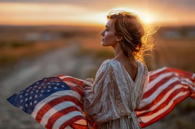 Young Woman Holding American Flag at Sunset