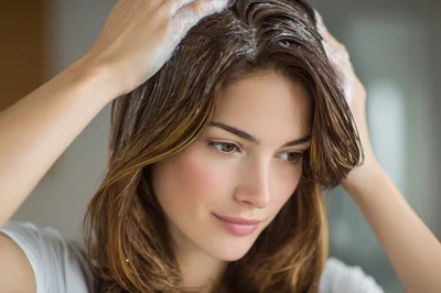Young Woman Washing Her Hair With Shampoo