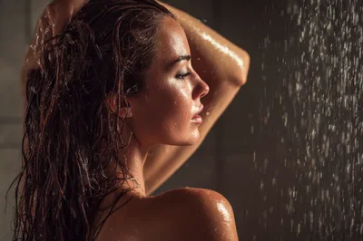 Woman Washing Her Hair Under A Shower
