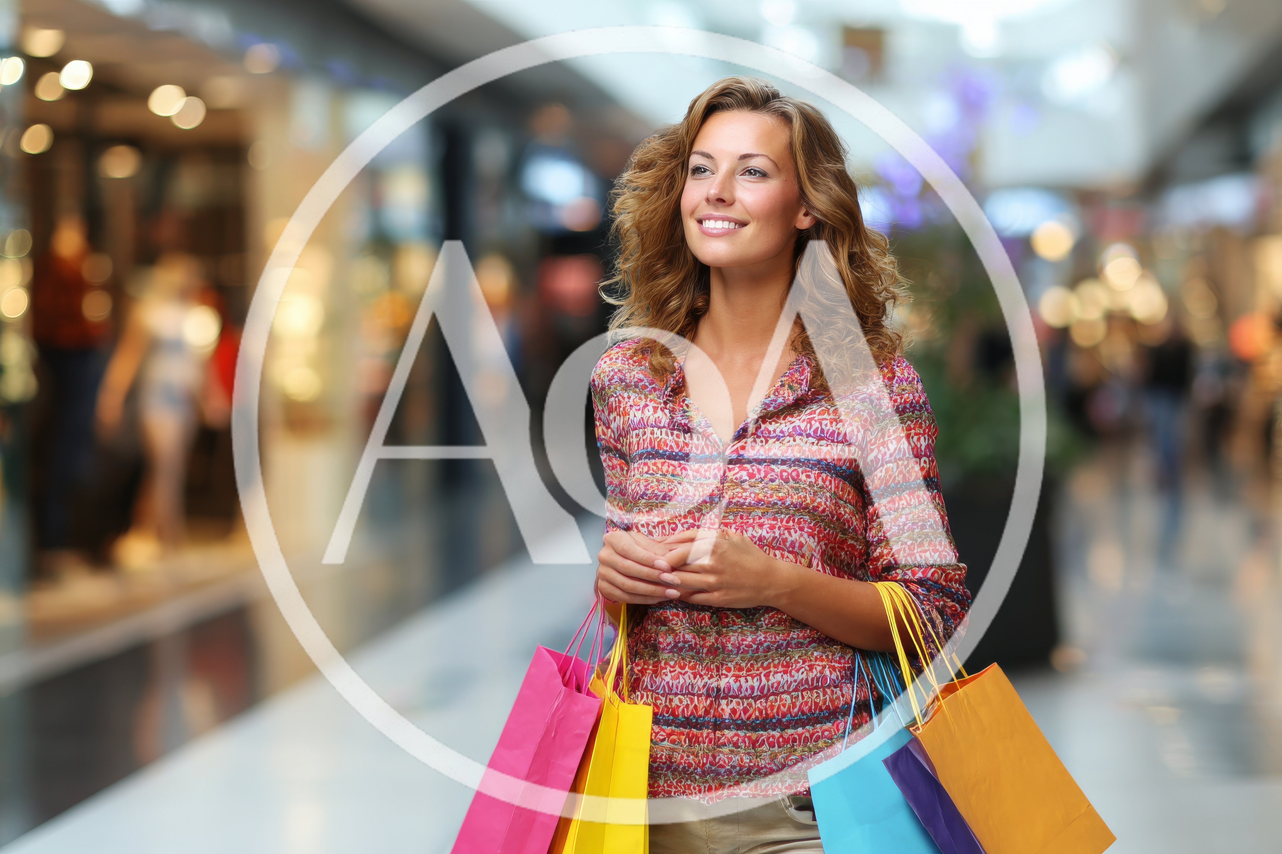 Happy Woman Carrying Shopping Bags In A Mall