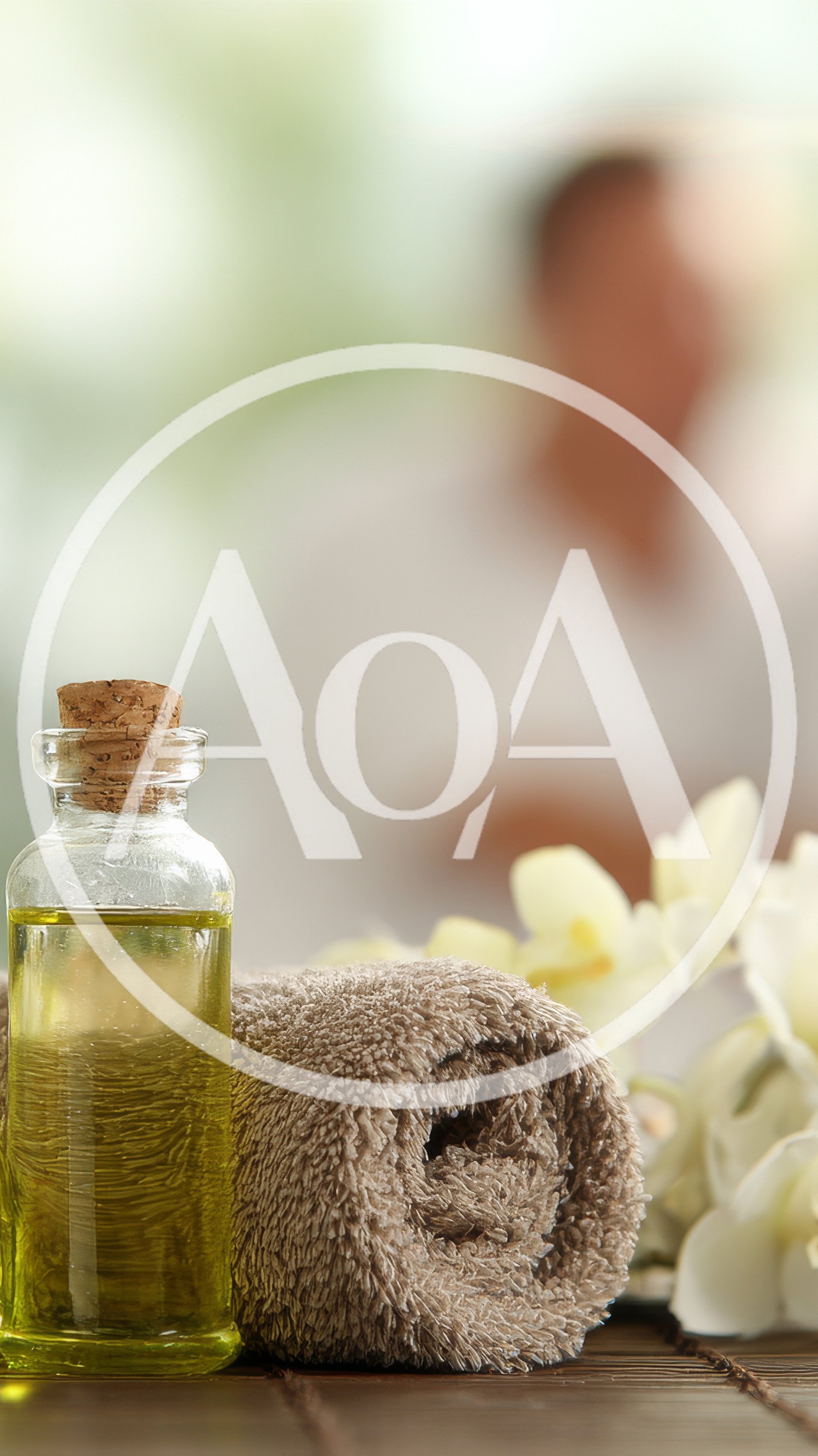 Spa Treatment Oil Bottle With Rolled Towel And Orchids