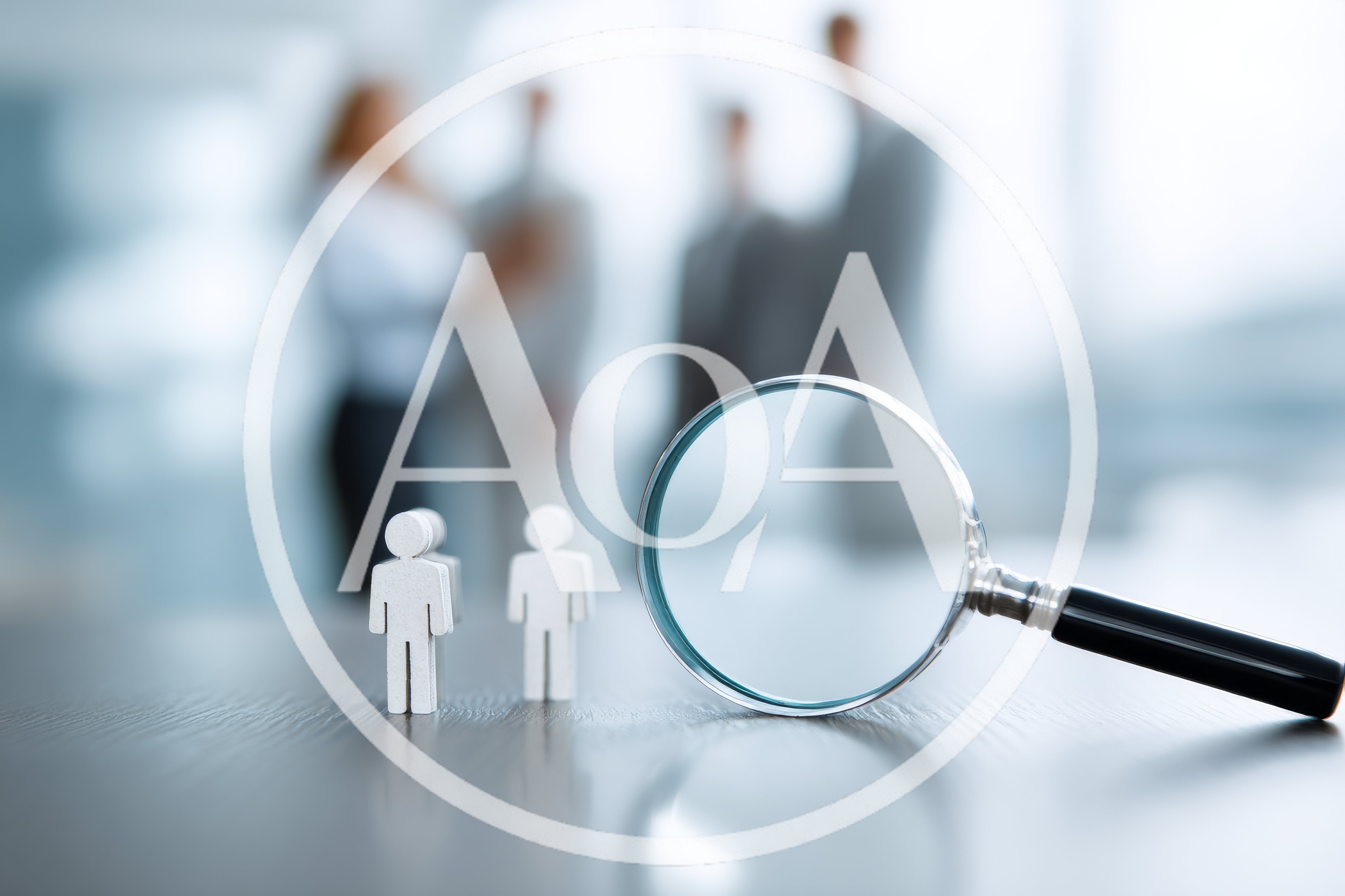 Magnifying Glass Focusing On Small Human Figurines