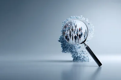 Magnifying Glass Focusing On Crowd Inside Human Head Silhouette