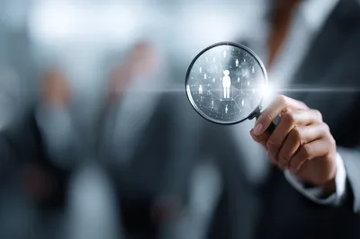 Business Professional Using Magnifying Glass To Find Talent