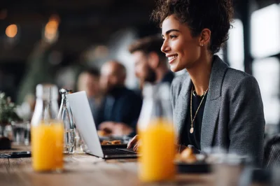 Professional Woman Working On Laptop In A Cafe