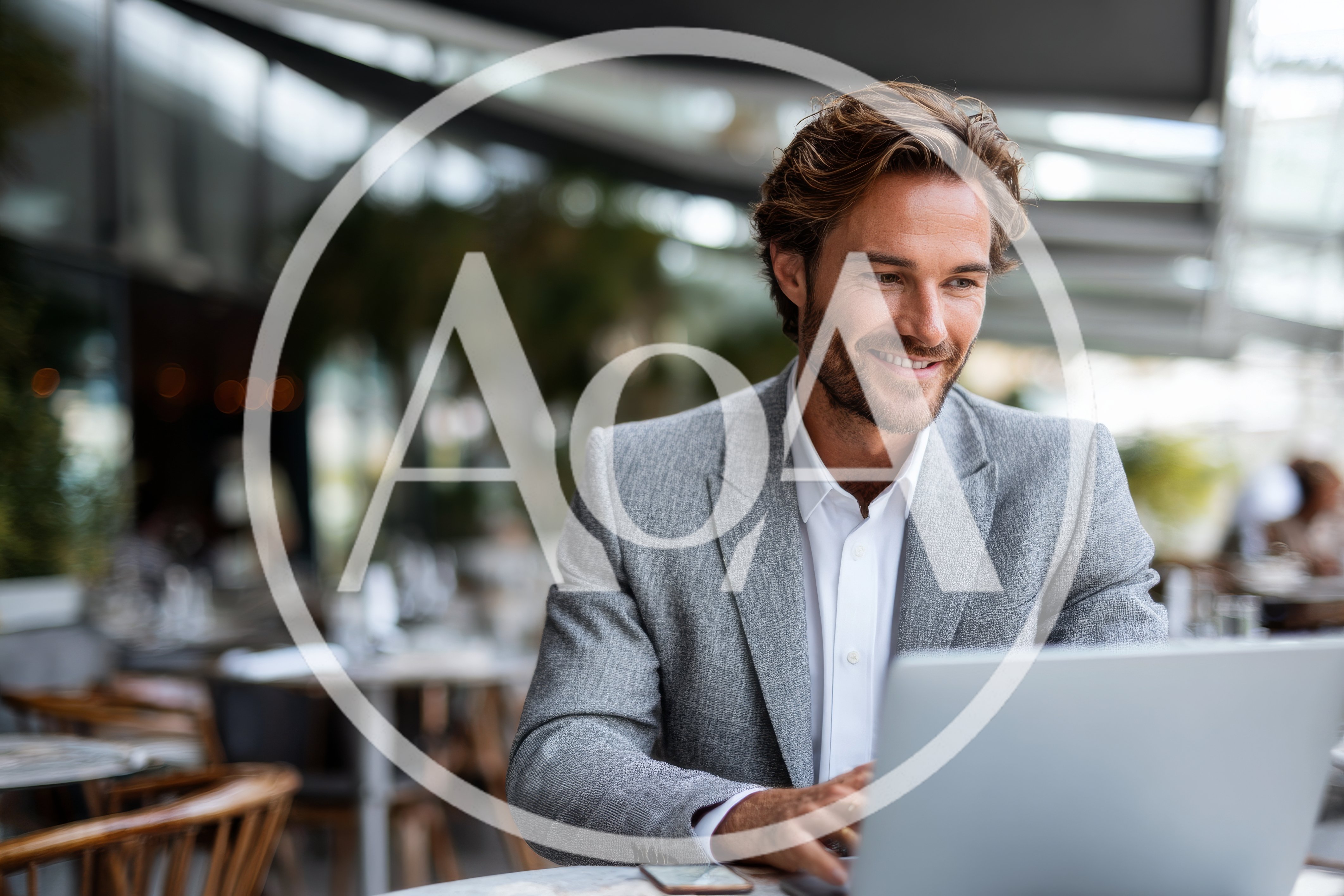 Professional Man Working On Laptop At Outdoor Cafe