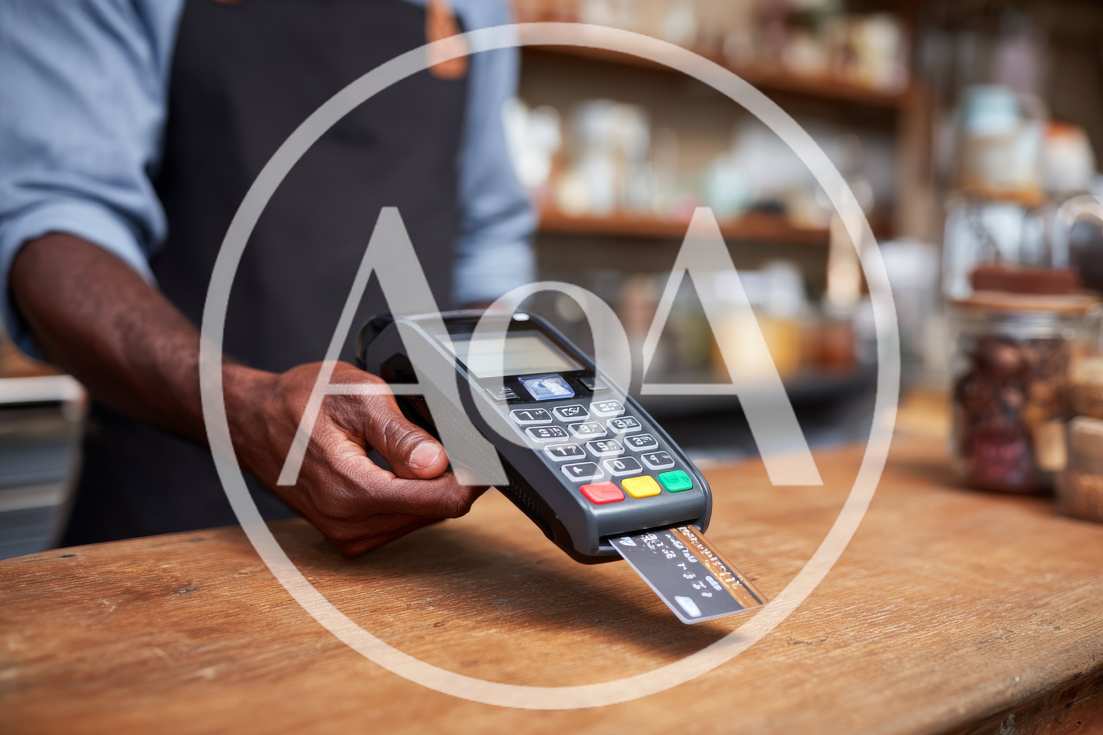 Barista Holding Payment Terminal With Inserted Credit Card