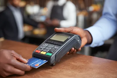 Customer Paying With Credit Card At Point Of Sale