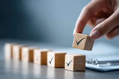 Hand Placing Wooden Block With Checkmark Symbol