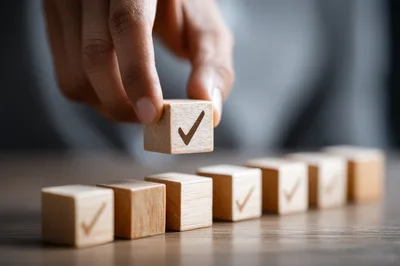 Hand Placing Wooden Block With Check Mark Symbol